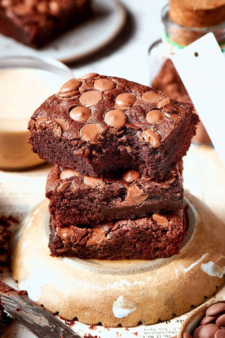 A stack of three fudgy brownies with chocolate chips
